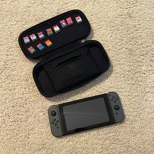 Gray Nintendo switch with charger, wireless controller, 12 games and carry case